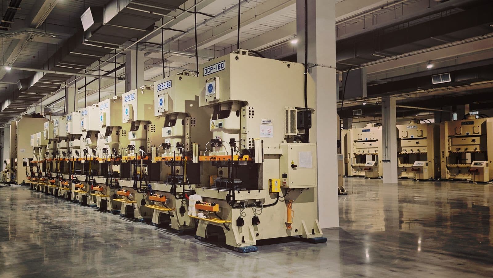 Precision manufacturing press machines on an industrial factory floor